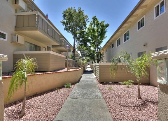 A pathway leads between two rows of buildings.