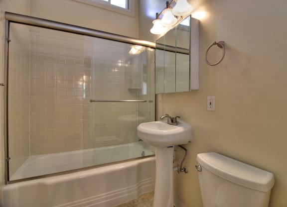 A white sink is on the counter of a bathroom.