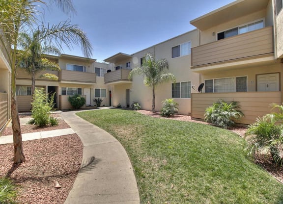 A sunny day at a residential complex with a clear blue sky.