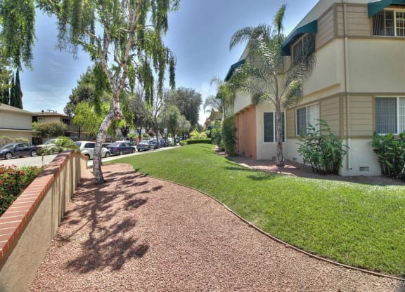 A residential street with a sidewalk and houses on both sides.