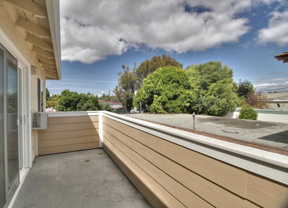 the view from the balcony of a home with a large deck