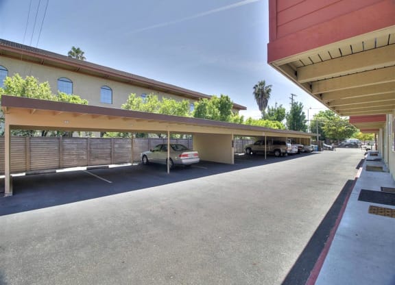 a parking lot with cars parked under a canopy
