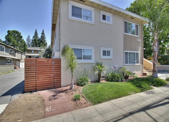 the front of a house with a yard and a sidewalk