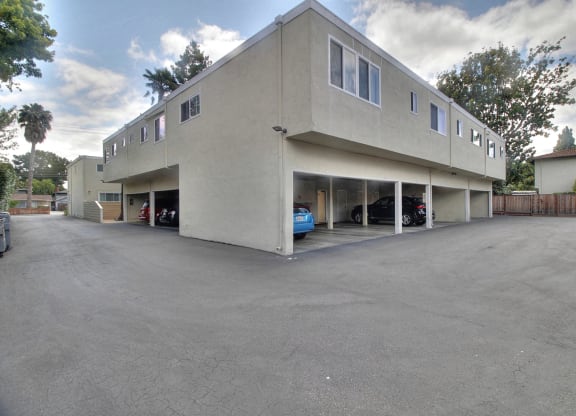 A large building with a parking lot in front.