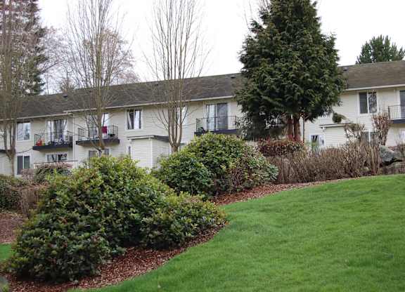 A grassy area in front of apartment buildings.