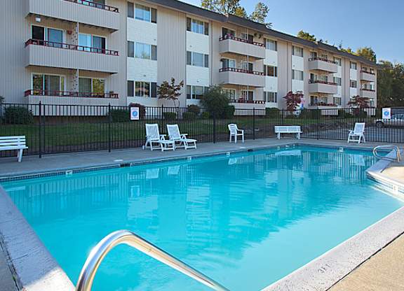 A swimming pool in front of apartment buildings.