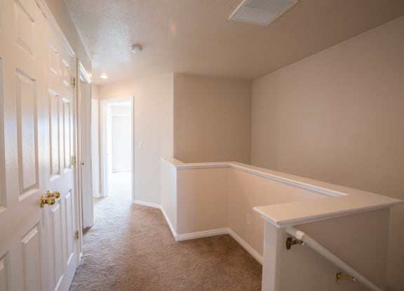 A white door with a gold handle is on the left.