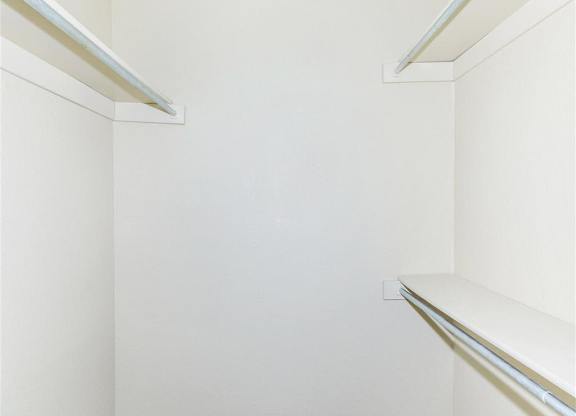 Empty white shelves in a room.