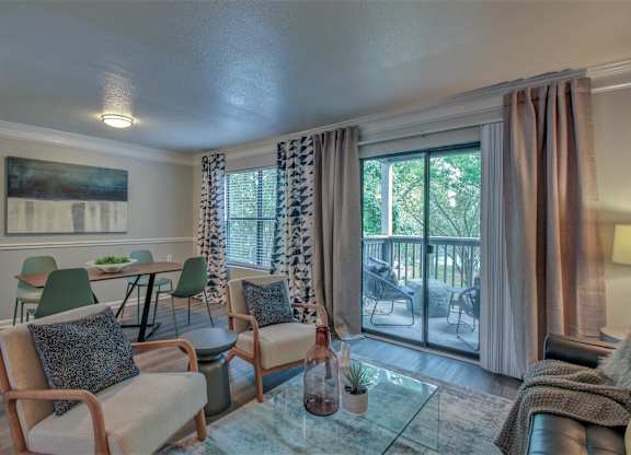 A living room with a glass table and chairs.