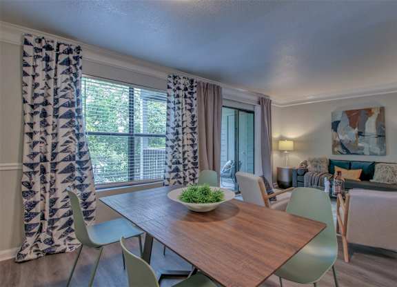 A dining room with a wooden table and chairs.