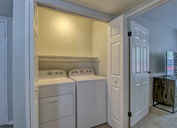 A small laundry room with a washer and dryer.