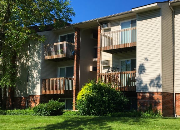 building with two balconies and a yard at Oakwood Apartments, Florence, KY