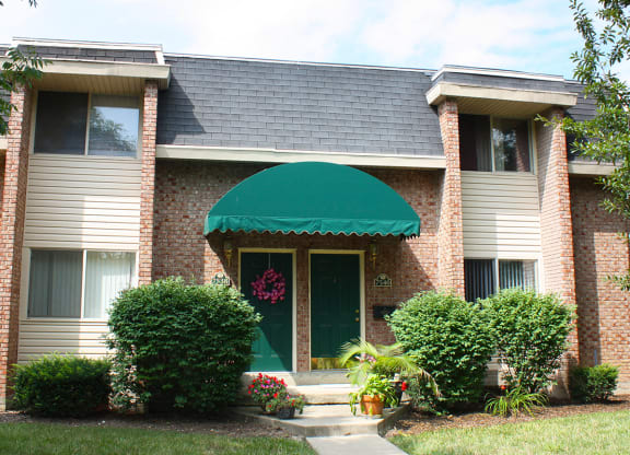 the front of a house with a green awning at Wentworth Estates Apartments, Kentucky