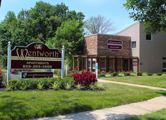 a building with a sign for a restaurant on the sidewalk at Wentworth Estates Apartments, Florence, KY, 41042
