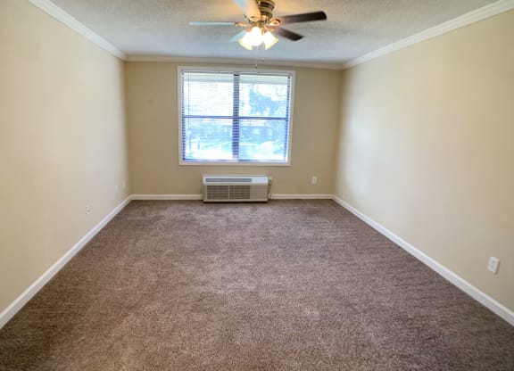 an empty living room with a ceiling fan and a window at Wentworth Estates Apartments, Florence, 41042