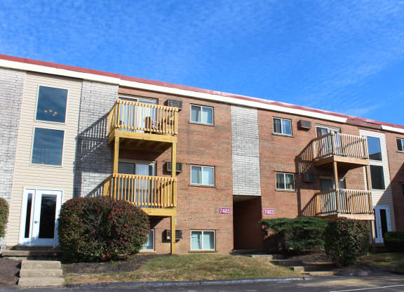 a brick apartment building with three balconies  at Wentworth Estates Apartments, Kentucky
