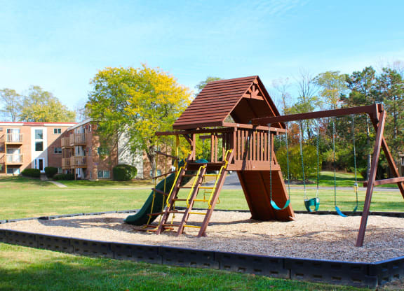 a playground with a swing set in a park  at Wentworth Estates Apartments, Kentucky