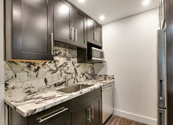 Glass Tiled Kitchen Backsplash at Woodcliff Apartments, Los Angeles, 90034