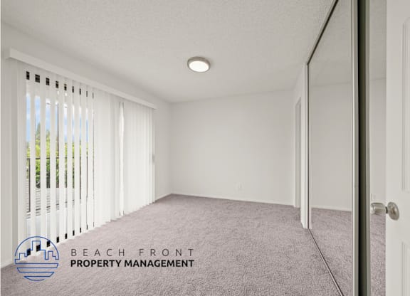 A room with a carpet floor and a door on the right side.