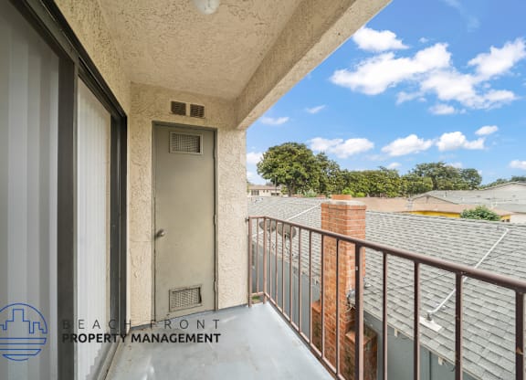 A balcony with a view of the sky and trees.