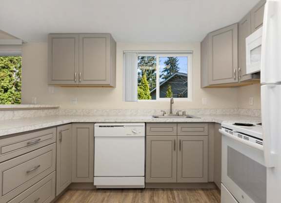 Renovated Kitchen with Grey Cabinets, Plank Flooring, and White Appliances at Woodlake Townhomes, Washington