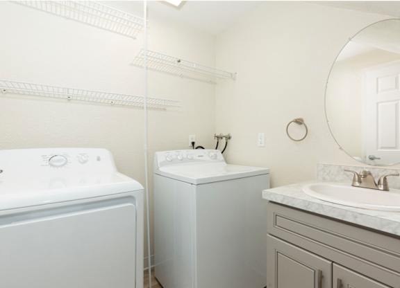 In-Unit Laundry Area with Vanity Sink, Cabinet, and Mirror at Woodlake Townhomes, Washington, 98026