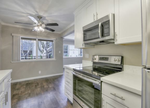 A kitchen with a stove top oven and a microwave above it.