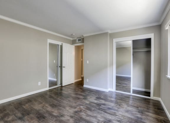 A room with a wooden floor and a sliding glass door.
