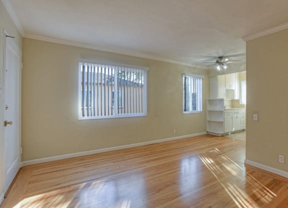 A room with wooden floors and a ceiling fan.