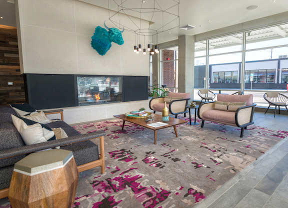 Interior resident lounge with ample seating and fireplace