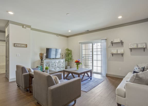 a living room with couches chairs and a table    and a door