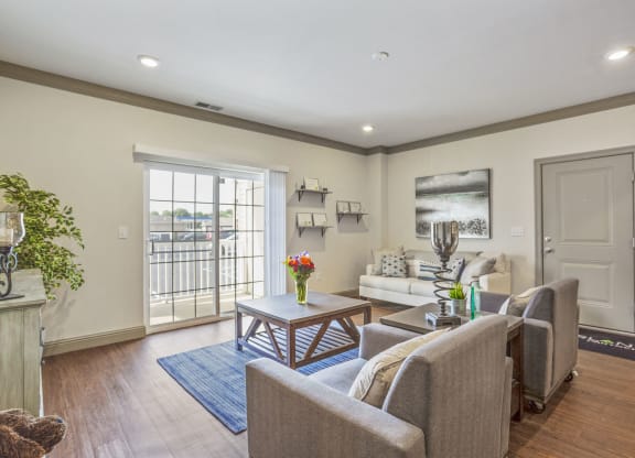 a living room with couches and chairs and a table