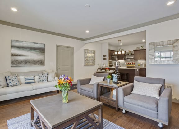 a living room with couches and chairs and a table