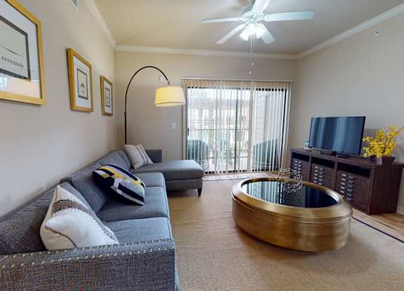Living room couch at Lakeland Estates Apartments in Stafford TX