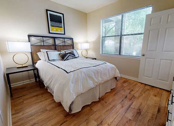 Bedroom with hardwood flooring at Lakeland Estates Apartments in Stafford TX