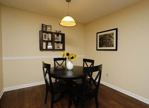a dining room with a table and chairs