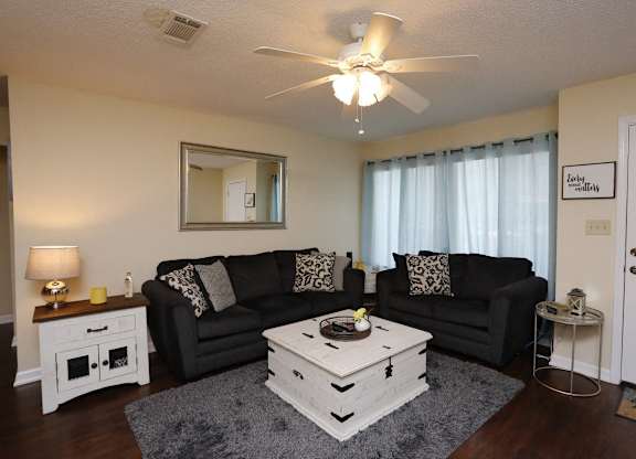 a living room with couches and a coffee table