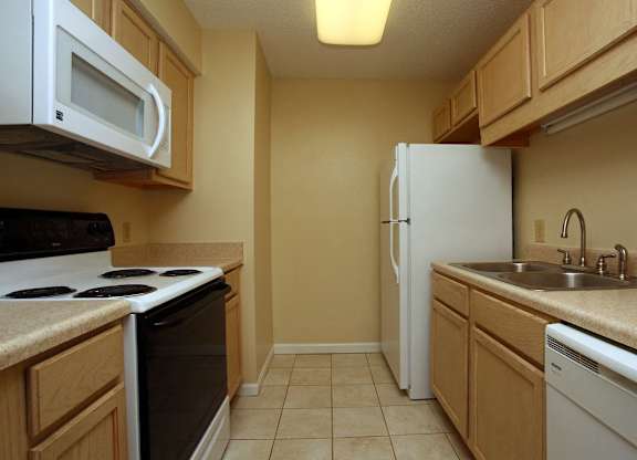 a kitchen with a stove refrigerator and sink
