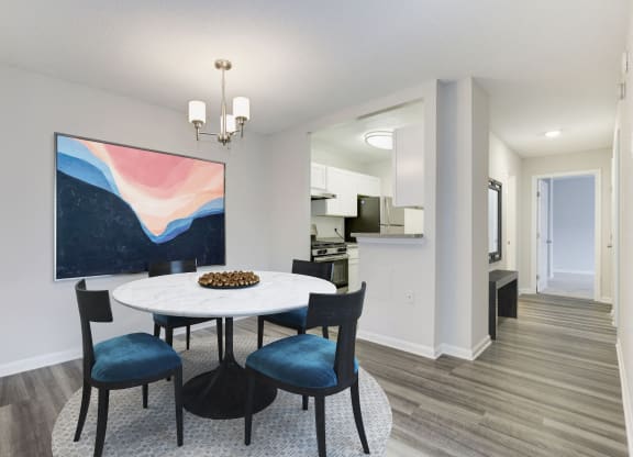 a dining room with a white table and blue chairs at Avondale Overlook, Maryland, 20782