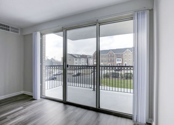 an open living room with sliding glass doors to a balcony at Avondale Overlook, Hyattsville