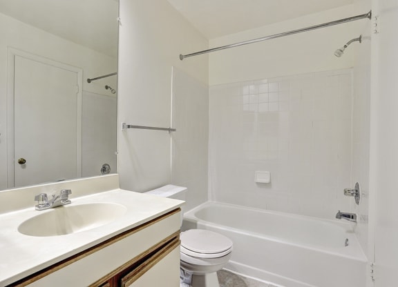 a bathroom with a sink toilet and a tub
