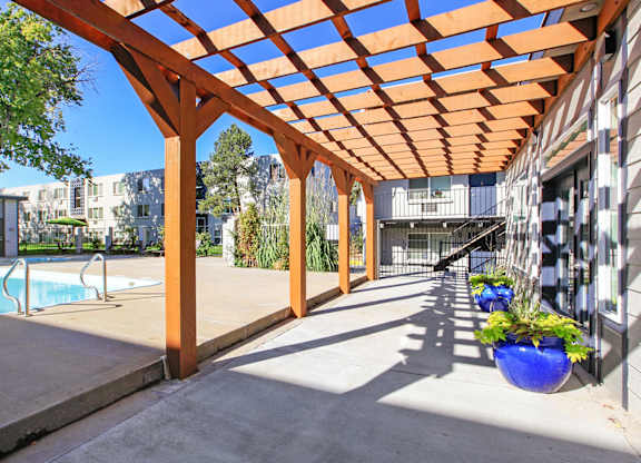 a covered patio with a pool in a building
