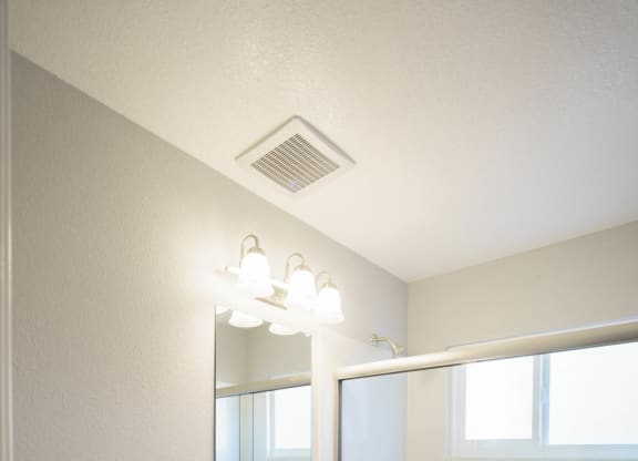 a bathroom with a toilet and a sink and a shower