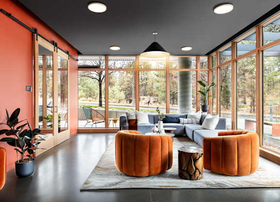 A living room with orange walls and furniture.