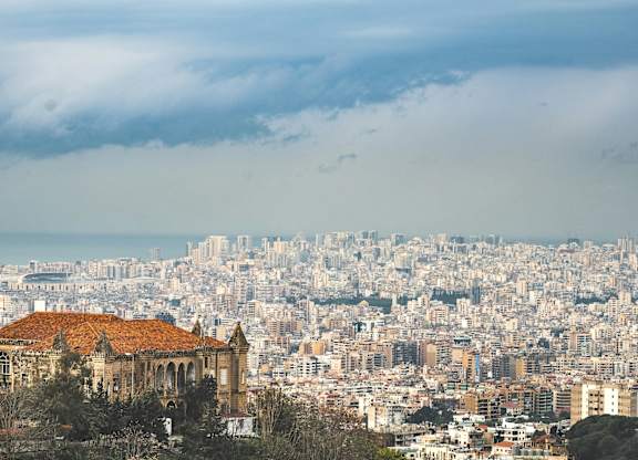 A cityscape with a prominent building in the foreground.