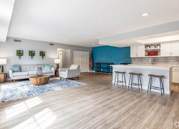 a living room with a kitchen and a couch