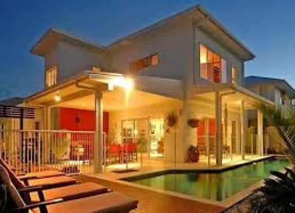 A modern house with a pool in the backyard.