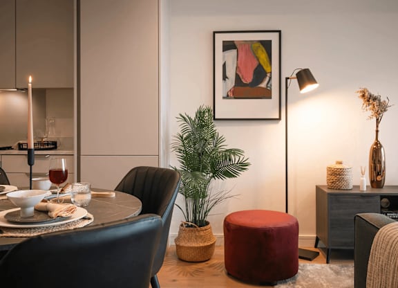 A modern dining room with a round table set for two. at Cherrywood Apartments, D18 VY3V, DUBLIN 18