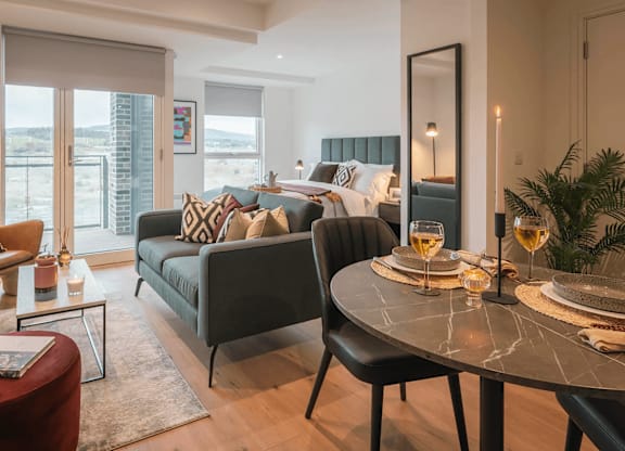 A modern living room with a glass table and a sofa. at Cherrywood Apartments, D18 VY3V