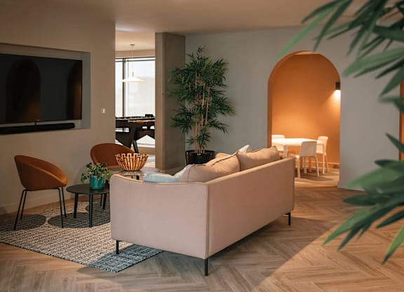 A living room with a couch, chairs, and a television. at Cherrywood Apartments, D18 VY3V